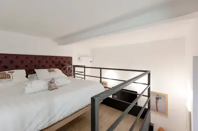 a bedroom with a large white bed with a red headboard at Restart Accommodations Colle Oppio e Paganini in Rome