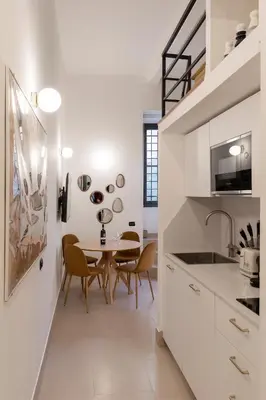 a kitchen and dining room with a table and chairs at Restart Accommodations Colle Oppio e Paganini in Rome