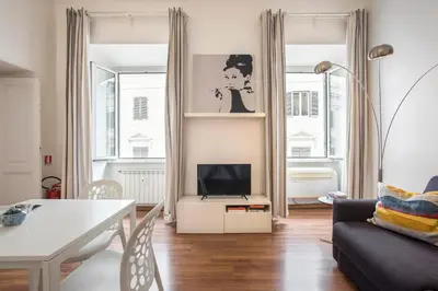 a living room with a couch and a tv at Minerva 2 Apartment in Rome