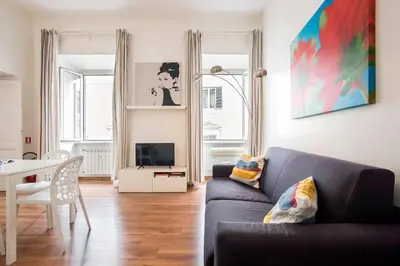 a living room with a couch and a table at Minerva 2 Apartment in Rome