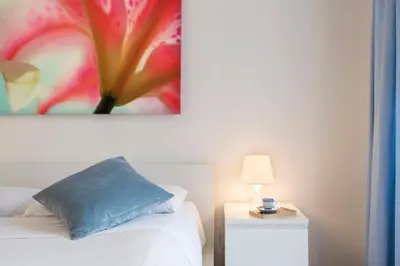 a bedroom with a bed and a painting on the wall at Minerva 2 Apartment in Rome