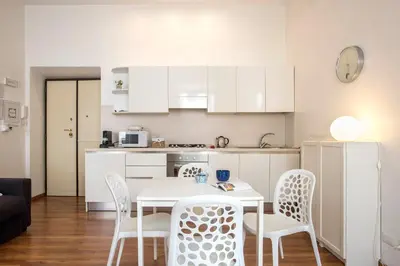 a kitchen with a table and chairs in a room at Minerva 2 Apartment in Rome