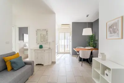 a living room with a couch and a table at Maison Lumiere, Design Apt 5 min from Tiburtina Station in Rome