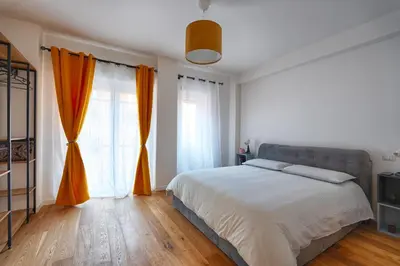 a bedroom with a large bed with orange curtains at Home Trastevere.62 in Rome