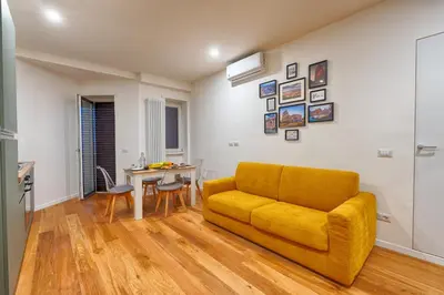 a living room with a yellow couch and a table at Home Trastevere.62 in Rome