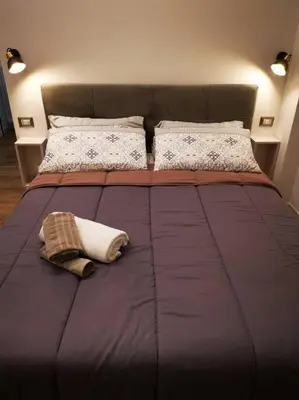 a large bed with a blanket on top of it at Friendly Apartment in Rome