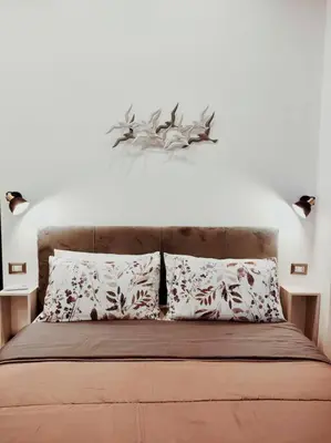 a bedroom with a bed with two pillows at Friendly Apartment in Rome