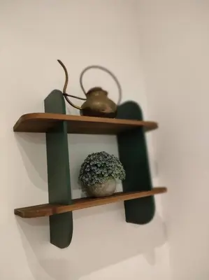 a shelf with a tea pot and a plant on a wall at Friendly Apartment in Rome