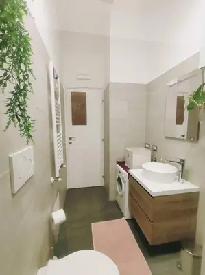 a bathroom with a toilet and a sink and a mirror at Friendly Apartment in Rome