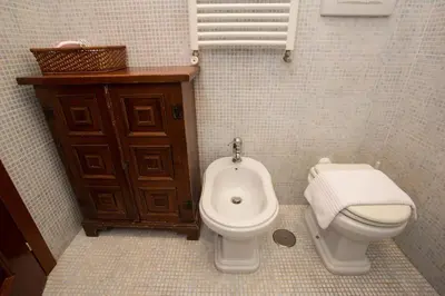 a bathroom with a toilet and a bidet at Vatican Fabio Massimo Apartment - Stay Inn Rome Experience in Rome