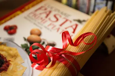 a book with a red ribbon on top of it at Vatican Fabio Massimo Apartment - Stay Inn Rome Experience in Rome