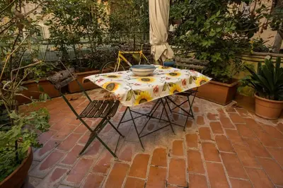 a table with a table cloth with a bowl on it at Vatican Fabio Massimo Apartment - Stay Inn Rome Experience in Rome