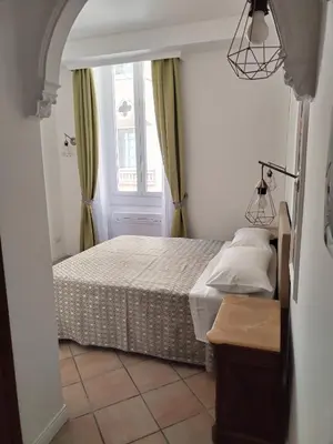 a small bedroom with a bed and a window at B&B L'Esquilina in Rome