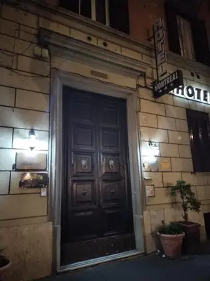 a door to a building with a sign above it at B&B L'Esquilina in Rome