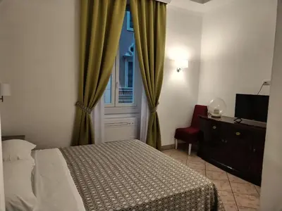 a bedroom with a bed and a window and a chair at B&B L'Esquilina in Rome