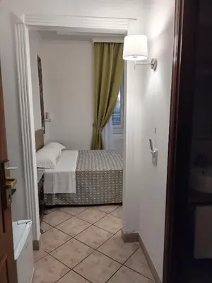 a small bedroom with a bed and a window at B&B L'Esquilina in Rome