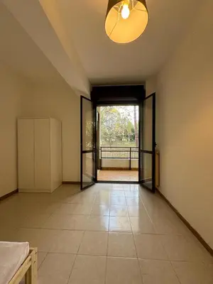an empty room with an open door to a balcony at RAHIMA GUEST HOUSE in Rome