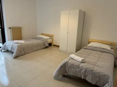 a room with two beds and a cabinet at RAHIMA GUEST HOUSE in Rome