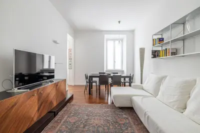 a living room with a white couch and a table at 3BR Comfort Apartment in Rome in Rome