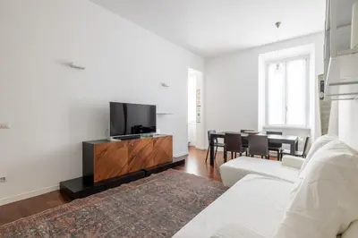 a living room with a white couch and a tv at 3BR Comfort Apartment in Rome in Rome
