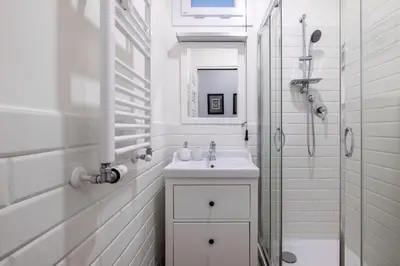 a white bathroom with a sink and a shower at 3BR Comfort Apartment in Rome in Rome