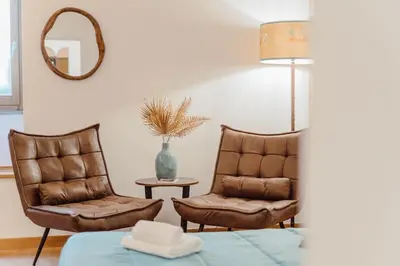 a bedroom with a large bed with a painting on the wall at La Grande Onda (Trastevere) in Rome