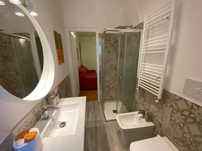 a bathroom with a sink and a toilet and a mirror at Camilluccia Dream Apartment in Rome
