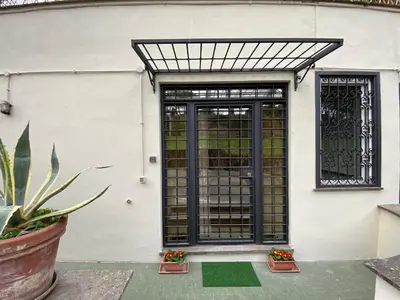 an entrance to a house with a black gate at Camilluccia Dream Apartment in Rome