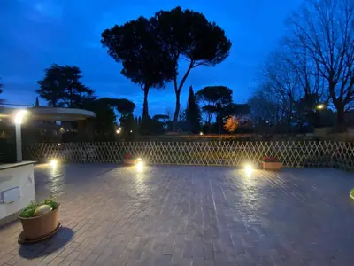 a patio lit up at night with lights at Camilluccia Dream Apartment in Rome