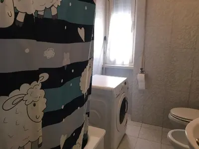 a bathroom with a washing machine and a washer at Perla Vaticana in Rome