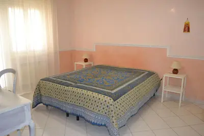 a bedroom with a bed with two tables and two lamps at Perla Vaticana in Rome