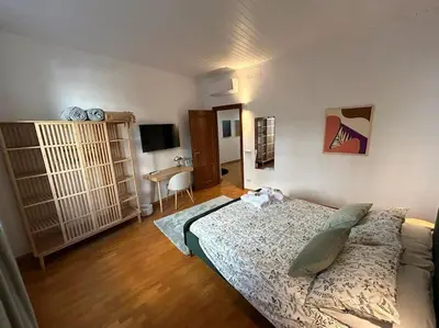 a bedroom with a bed and a desk in it at Trastevere Monteverde Velia House in Rome