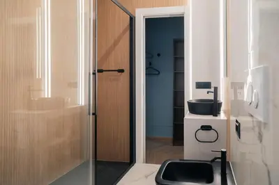 a bathroom with a toilet and a glass door at Victorian House, Rome Center in Rome