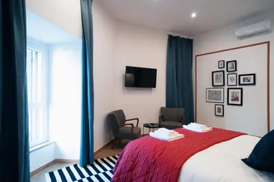 a hotel room with a red bed and a mirror at Victorian House, Rome Center in Rome
