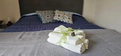 a pile of towels sitting on top of a bed at Corona House in Rome