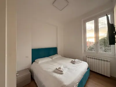 a bedroom with a bed with towels on it at San Lorenzo House in Rome