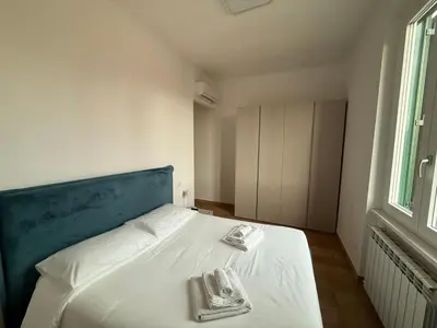 a bedroom with a bed with two towels on it at San Lorenzo House in Rome