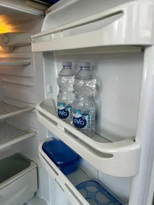 two bottles of water in an open refrigerator at The Attic Apartment in Rome