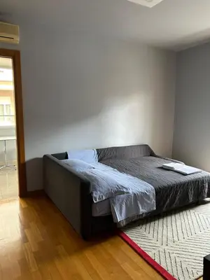 a bedroom with a bed in a room with a rug at The Attic Apartment in Rome