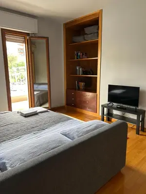 a bedroom with a bed and a flat screen tv at The Attic Apartment in Rome