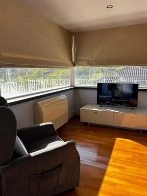 a living room with a couch and a flat screen tv at The Attic Apartment in Rome