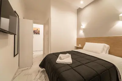 a bedroom with a bed with a black blanket at TERMINI HOLIDAY in Rome