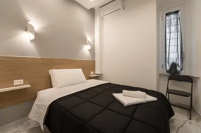 a bedroom with a bed with two towels on it at TERMINI HOLIDAY in Rome