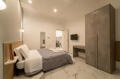 a bedroom with a king sized bed and a bathroom at TERMINI HOLIDAY in Rome