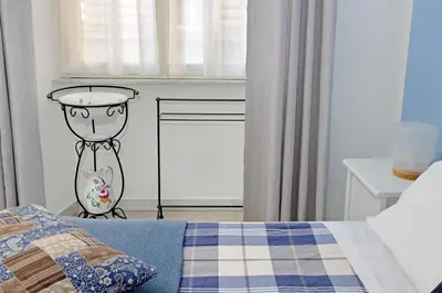 a kitchen with a washer and a washing machine at CASA GIULIANA - 3BR 2BATH, 2nd floor historic mansion with lift & doorman, chic, family friendly with baby equipment, 600 meters from Vatican & Ottaviano metro, quietest area of P R A T I wealthy, secure, accessible district - Guest care in 4 languages in Rome