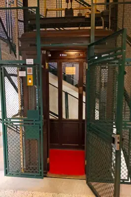 a black door with a gate in a building at CASA GIULIANA - 3BR 2BATH, 2nd floor historic mansion with lift & doorman, chic, family friendly with baby equipment, 600 meters from Vatican & Ottaviano metro, quietest area of P R A T I wealthy, secure, accessible district - Guest care in 4 languages in Rome