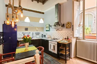 a kitchen with a table and a stove top oven at Rome as you feel - Vicolo delle Grotte in Rome