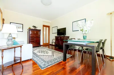a living room with a table and a couch at Appia Nuova Lucrezia Apartment in Rome