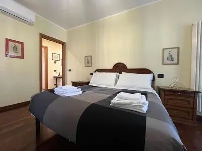 a bedroom with a large bed with towels on it at Appia Nuova Lucrezia Apartment in Rome