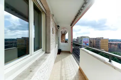 a balcony with a view of a city at Appia Nuova Lucrezia Apartment in Rome